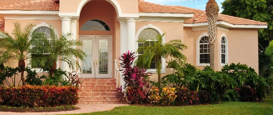 Neat landscaping with colorful plants in a yard in West Palm Beach, FL.