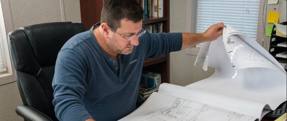 Owner of the company looking at blueprints in West Palm Beach, FL.