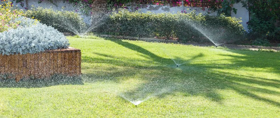 Sprinkler irrigation watering a lawn and plants in Greenacres, FL.