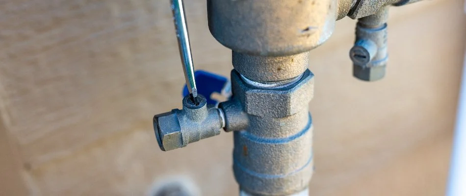 Tightening a valve in an irrigation system in West Palm Beach, FL.